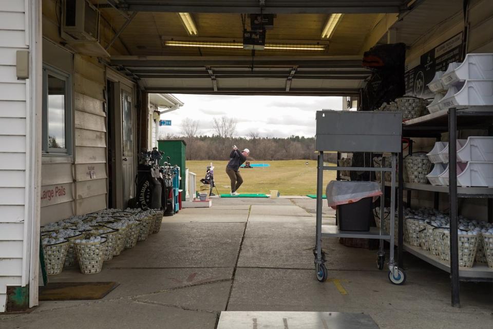 A golfer takes a swing at 19th Tee Driving range in Kanata. The range was packed as golfers look to get in some early season swings on Saturday.