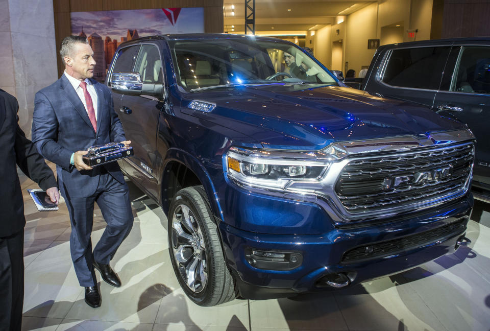 Reid Bigland, head of the Ram brand, walks next to the Ram 1500 pickup truck, after it was awarded the 2019 North American Truck of the Year at the North American International Auto Show, Monday, Jan. 14, 2019, in Detroit, Mich. (AP Photo/Tony Ding)