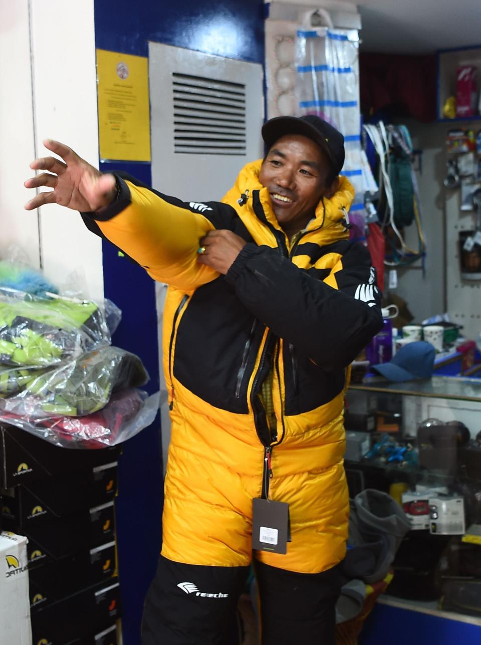 In this photograph taken on March 26, 2018, Nepali mountaineer Kami Rita Sherpa, 48, tries on a climbing jacket in Kathmandu.