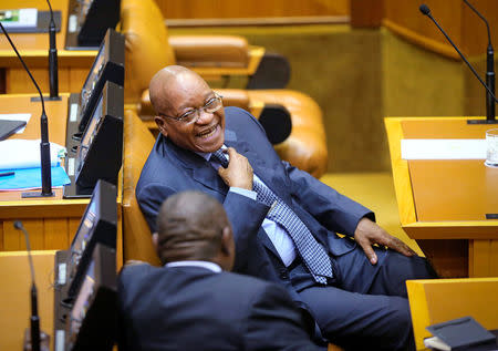 South African President Jacob Zuma laughs ahead of Finance Minister Pravin Gordhan's medium term budget speech in Cape Town, South Africa October 26, 2016. REUTERS/Sumaya Hisham