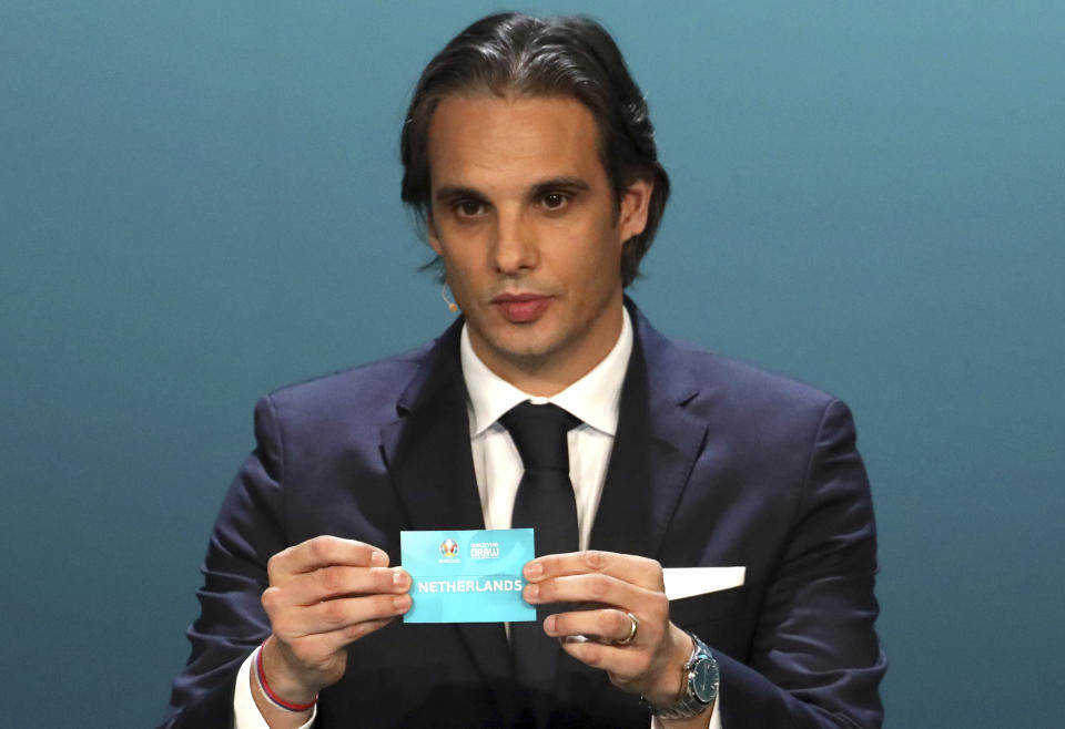 Former Portuguese soccer player Nuno Gomes draws the Netherlands during the UEFA Euro 2020 European soccer championship qualifying draw at the Convention Centre in Dublin, Ireland, Sunday, Dec. 2, 2018. (AP Photo/Peter Morrison)