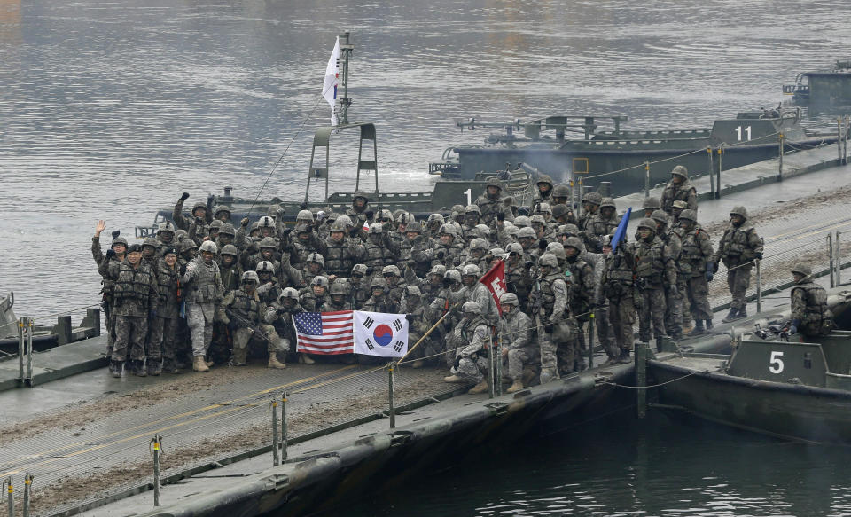 FILE - In this Dec. 10, 2015, file photo, U.S. and South Korean army soldiers pose on a floating bridge on the Hantan river after a river crossing operation, part of an annual joint military exercise between South Korea and the United States in Yeoncheon, south of the demilitarized zone that divides the two Koreas, South Korea. Ahead of the second summit between U.S. President Donald Trump and North Korean leader Kim Jong Un, some observers say there is an uncertainty over the future of the decades-long military alliance between Washington and Seoul. (AP Photo/Ahn Young-joon, File)