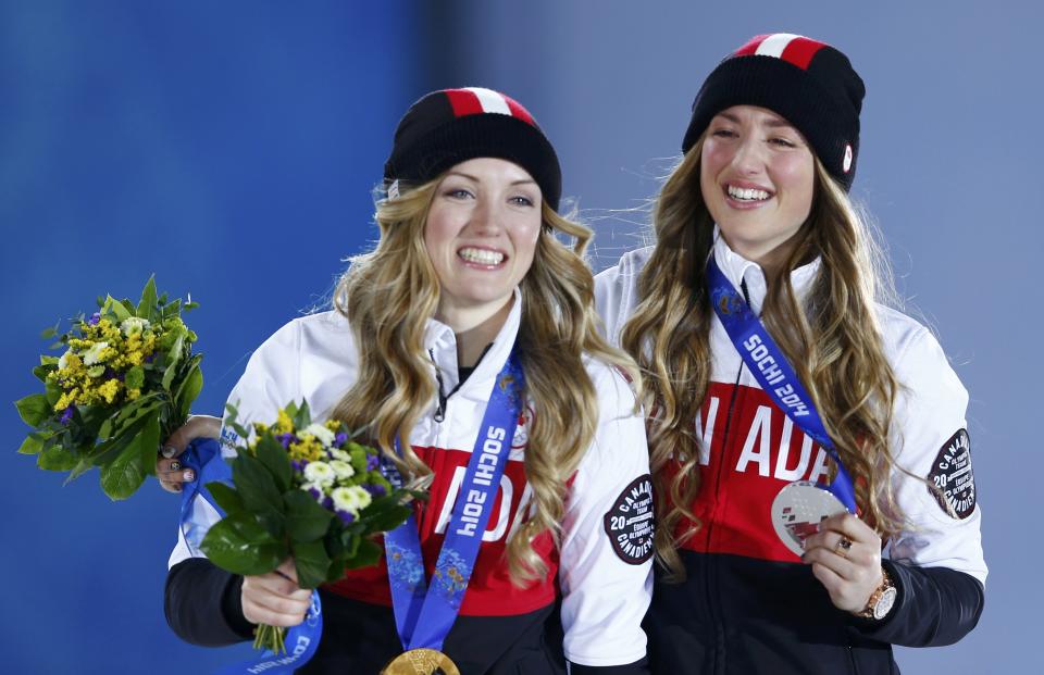 Gold medalist Justine Dufour-Lapointe of Canada and her compatriot, silver medalist Dufour-Lapointe, pose during the medal ceremony for the women's freestyle skiing moguls at the Sochi 2014 Sochi Winter Olympics