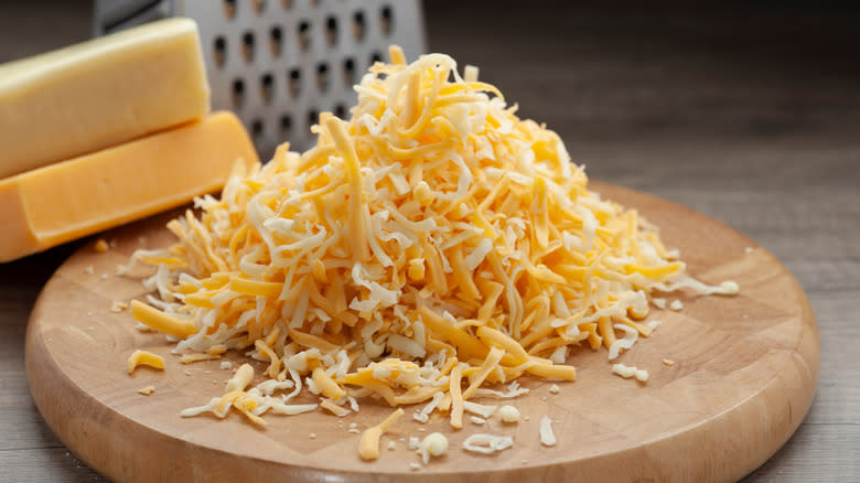 Grated cheese on cutting board