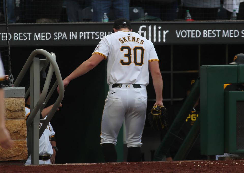 Pittsburgh Pirates starting pitcher Paul Skenes walks into the dugout after being pulled during the fifth inning of his MLB Debut against the Chicago Cubs Saturday evening at PNC Park in Pittsburgh, PA.