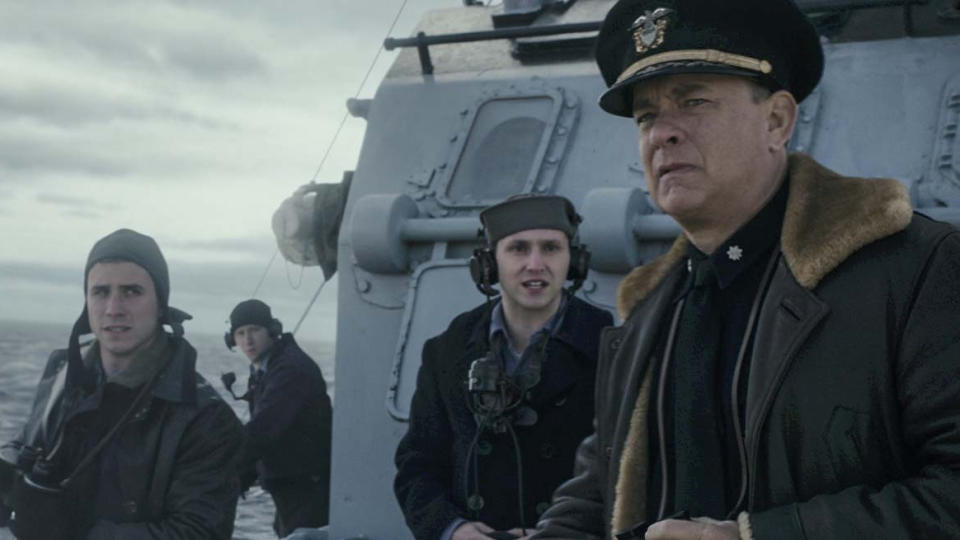 Tom Hanks and other sailors on the deck of a warship.