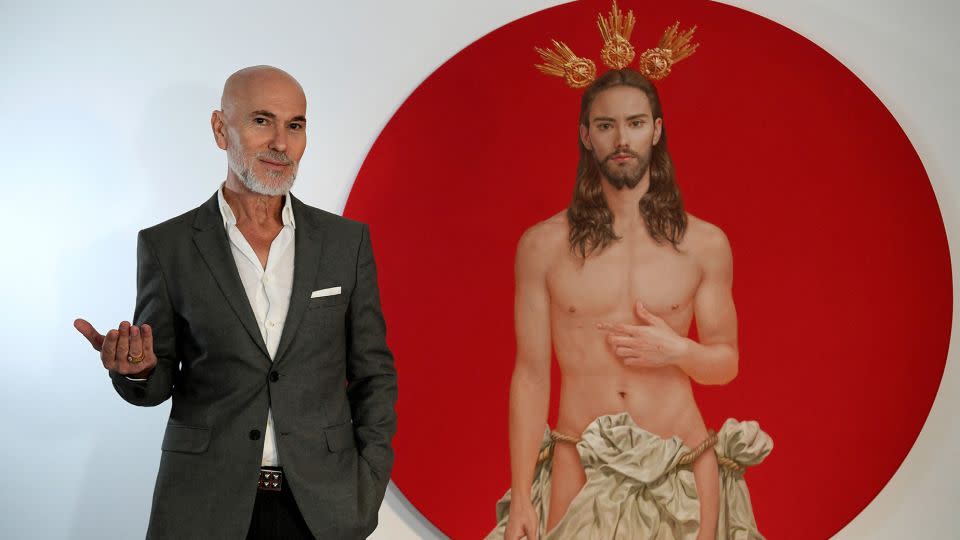 Spanish artist Salustiano García Cruz next to the Christ he painted for the official poster of "Semana Santa de Sevilla 2024," Sevilla's Holy Week celebrations. The poster aroused the anger of ultra-conservatives, who demand its withdrawal, deeming it "offensive" for Catholics. - Cristina Quicler/AFP/Getty Images