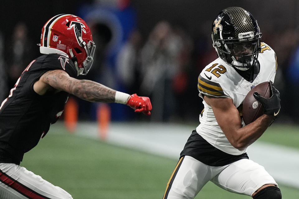 New Orleans Saints wide receiver Chris Olave (12) runs against Atlanta Falcons safety Jessie Bates III (3) during the first half of an NFL football game, Sunday, Nov. 26, 2023, in Atlanta. (AP Photo/Brynn Anderson)