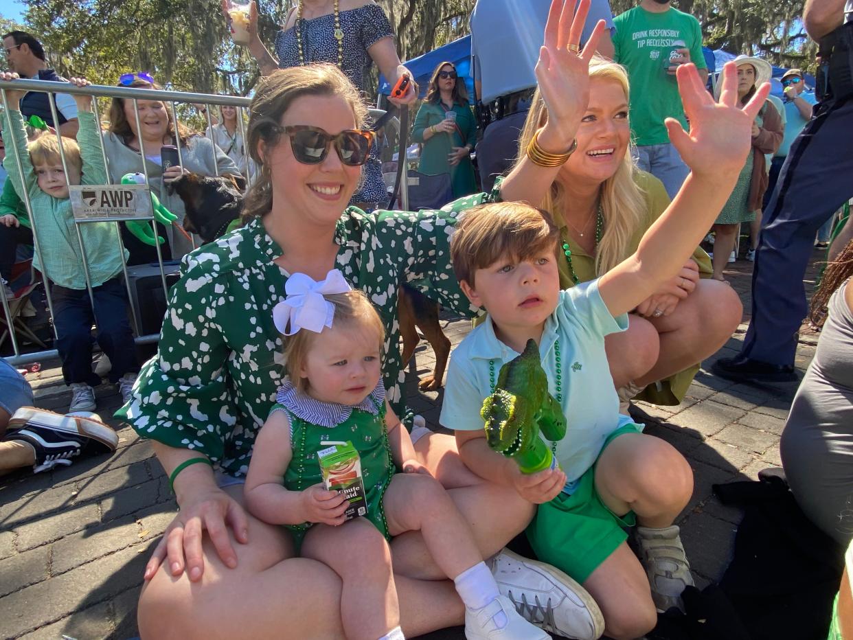 Kate Jackson, Sara Collins, Trip Jackson, and Morgan Carter wave as a U.S. Navy float passes.