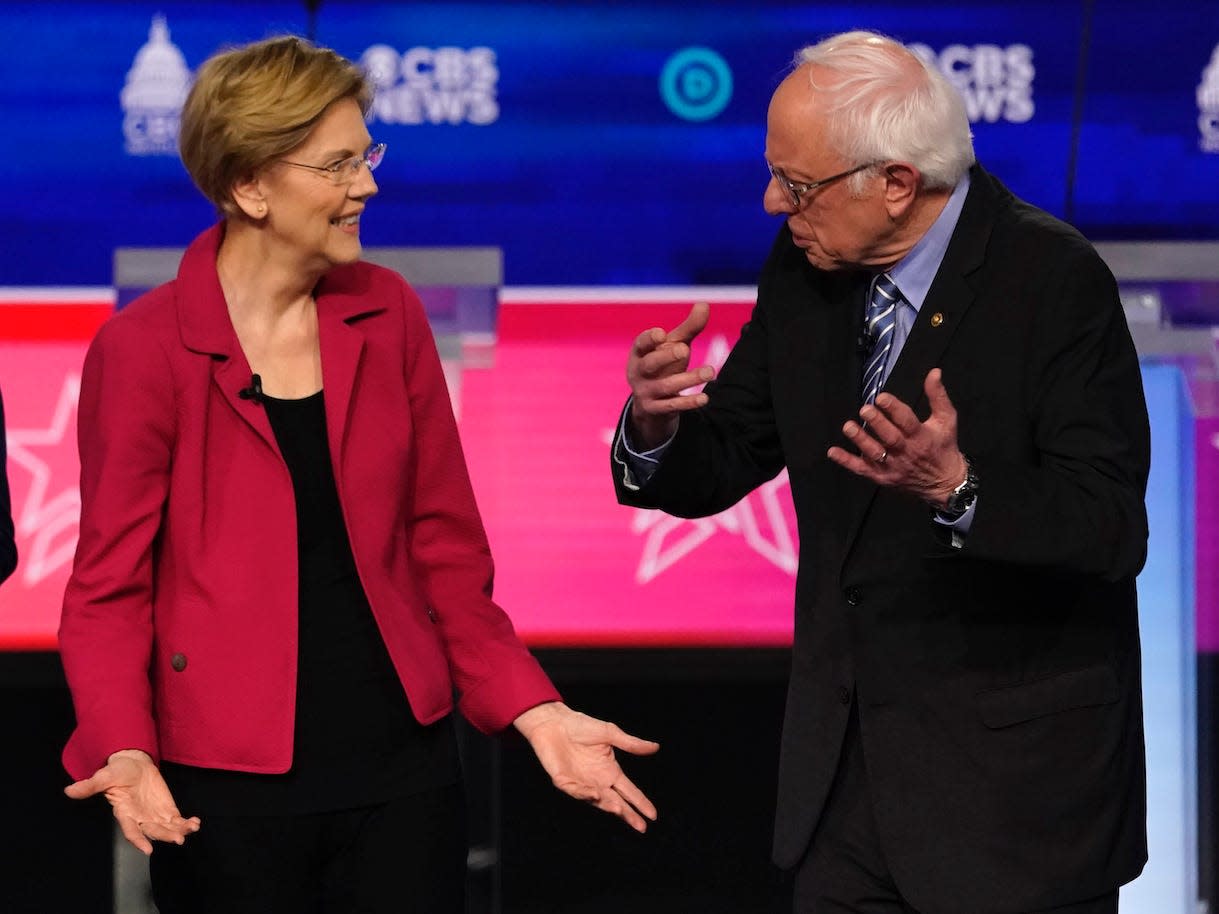 Sens. Elizabeth Warren and Bernie Sanders talk before the tenth Democratic 2020 presidential debate in South Carolina.