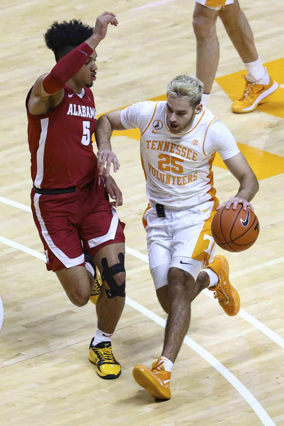 Tennessee guard Santiago Vescovi (25) moves the ball against Alabama's Jaden Shackelford (5) during an NCAA college basketball game Saturday, Jan. 2, 2021, in Knoxville, Tenn. (AP Photo/Randy Sartin, Pool)