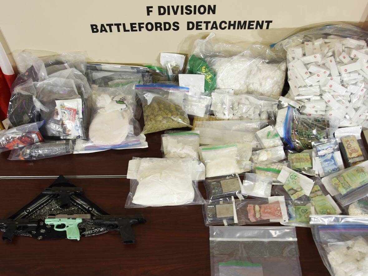 In total, officers seized nearly eight kilograms of what they suspect to be cocaine, 281 grams of Xanax tablets, more than 5,000 pre-rolled cannabis joints, 898 cartons of contraband cigarettes, more than 10 kilograms of cutting agent, a large sum of cash and four illegally-possessed handguns, police say. (Battleford RCMP - image credit)