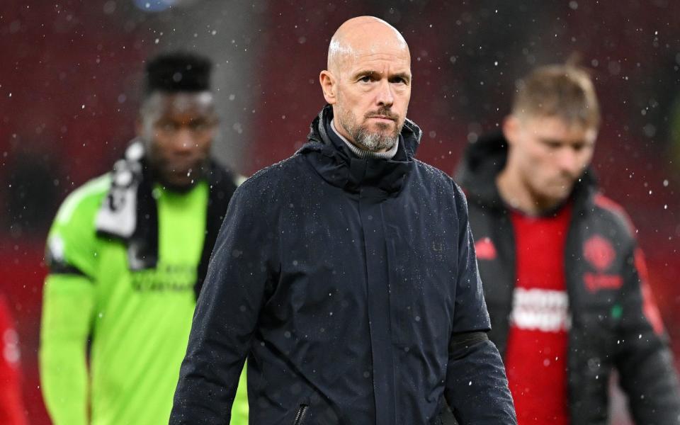 Erik ten Hag, manager of Manchester United, looks dejected after his team's defeat by Manchester City