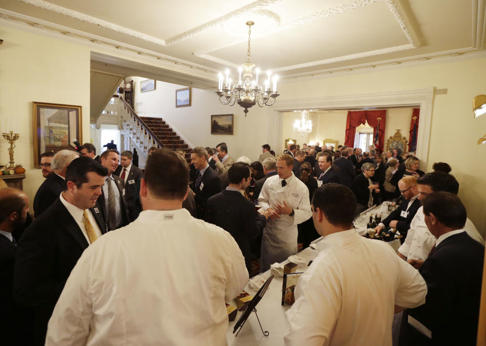 Visitors to the Executive Mansion sample New York state products after an earlier "Wine, Beer and Spirits Summit" at the Empire State Plaza on Wednesday, Oct. 24, 2012, in Albany, N.Y. The aim of the summit is to boost wine production and craft brewers, in part to spur job growth. (AP Photo/Mike Groll)