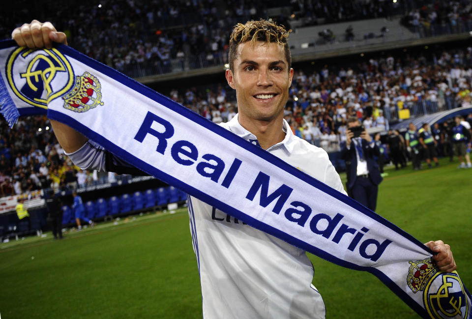 FILE - In this Sunday, May 21, 2017 file photo, Real Madrid's Cristiano Ronaldo celebrates after winning the Spanish La Liga title at the end of the soccer match between Malaga and Real Madrid in Malaga, Spain. Ronaldo, who joined Juventus for this season from Real Madrid, became the first player to win the English Premier League (with Manchester United), the Spanish league (with Madrid) and Serie A. (AP Photo/Daniel Tejedor, File)