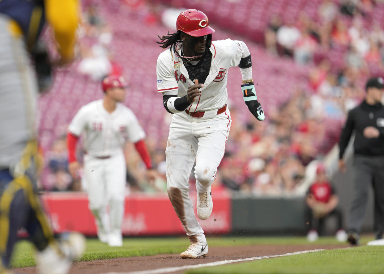 CINCINNATI, OHIO - APRIL 08: Elly De La Cruz #44 of the Cincinnati Reds scores on a ground out hit by Santiago Espinal #4 during the second inning of a baseball game against the Milwaukee Brewers at Great American Ball Park on April 08, 2024 in Cincinnati, Ohio. (Photo by Jeff Dean/Getty Images)
