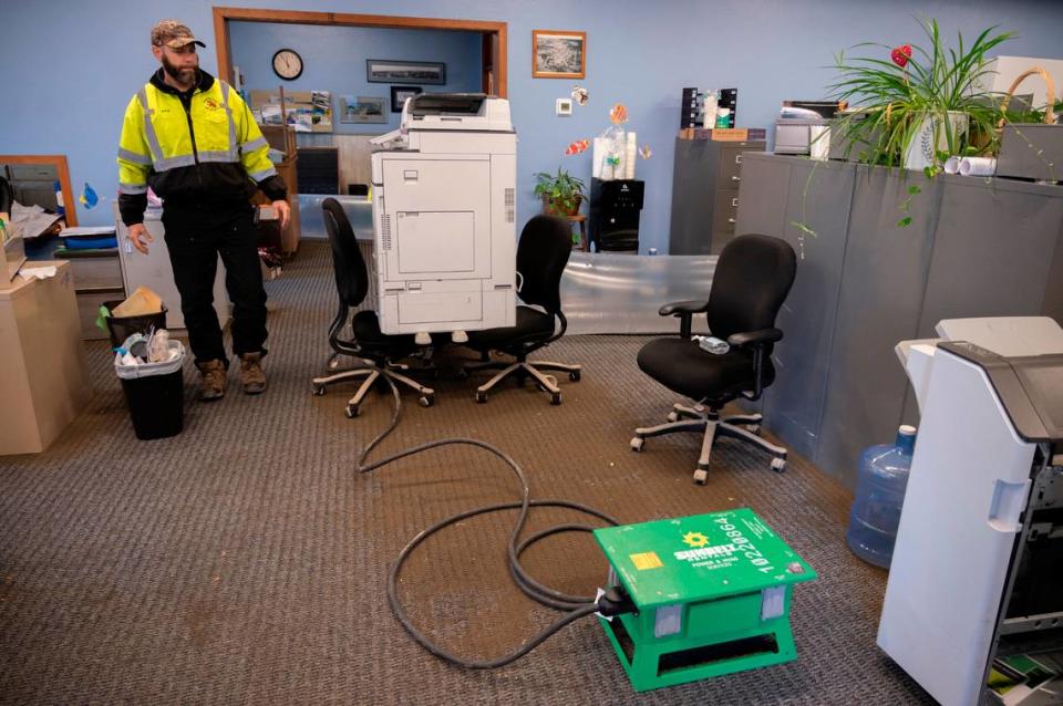 Mayor Kyle Christiansen assesses damages inside Sumas City Hall after flood waters receded from a storm on Friday, Nov. 19.