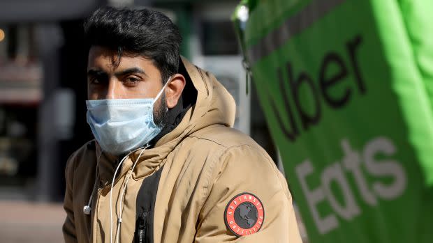 An Uber Eats courier wearing a protective face mask.