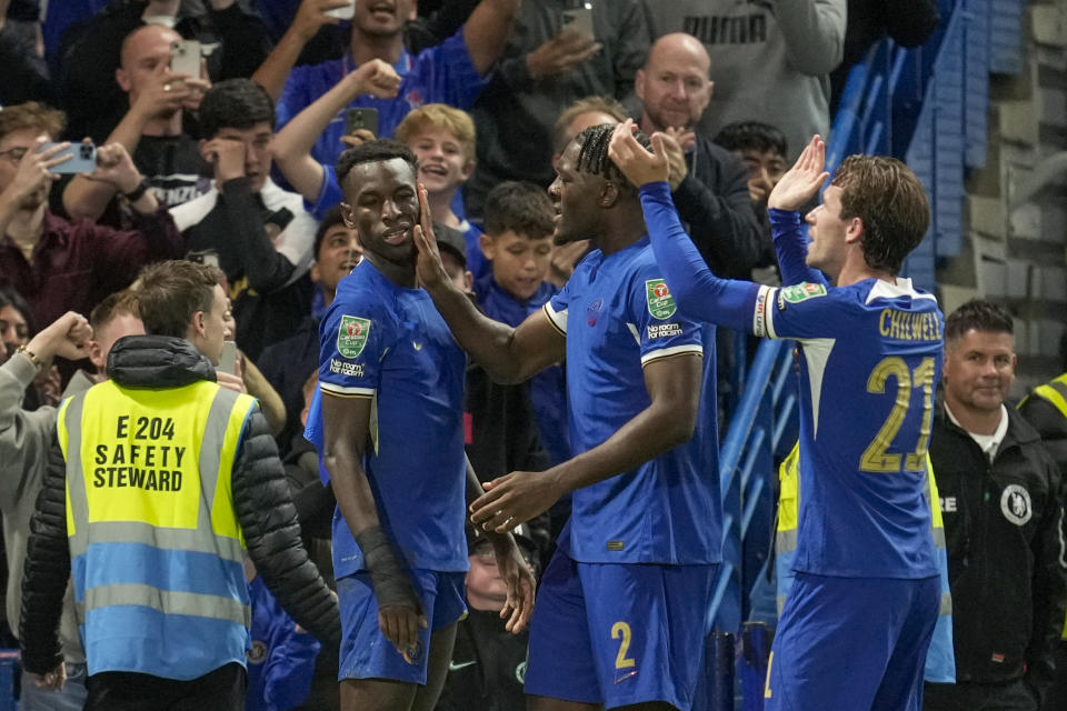 Chelsea's Nicolas Jackson celebrates with teammates after scoring his side's opening goal during the English League Cup third round soccer match between Chelsea and Brighton at Stamford Bridge Stadium in London, Wednesday, Sept. 27, 2023. (AP Photo/Kin Cheung)