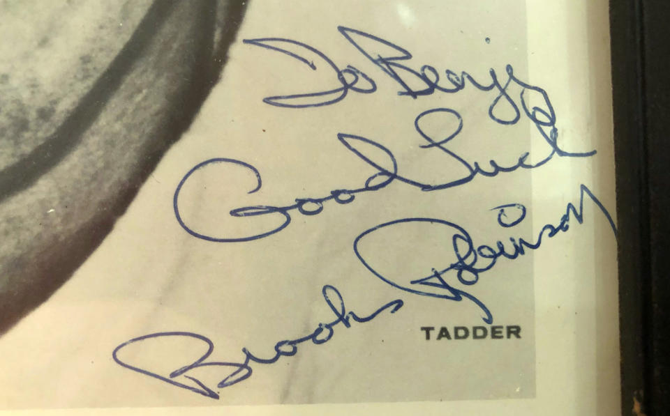 In a photo provided by Ben Walker, a signed photograph of Brooks Robinson to Benjy Walker is seen in Ben Walker's boyhood home, Tuesday, Sept. 26, 2023, in Rockville, Md. Walker received the photo in fourth grade. Robinson, whose deft glovework and folksy manner made him one of the most beloved and accomplished athletes in Baltimore history, has died. He was 86. (Ben Walker via AP)