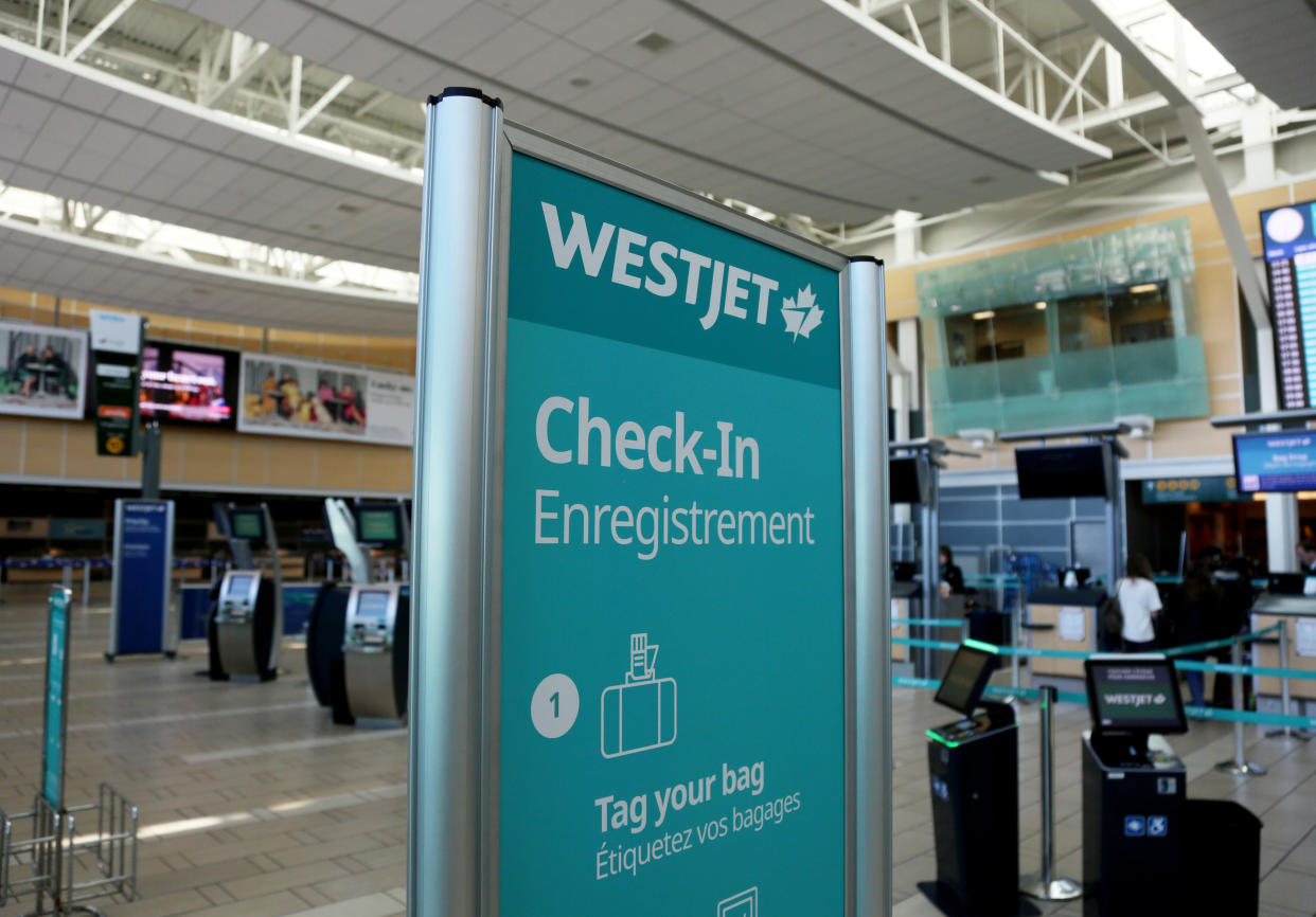 WestJet airline signage is pictured at Vancouver's international airport in Richmond, British Columbia, Canada, February 5, 2019.  REUTERS/Ben Nelms