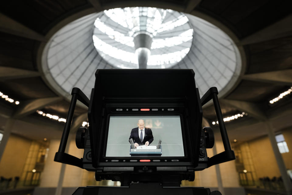German Chancellor Olaf Scholz is seen on a tv camera screen as he delivers a speech about Germany's budget crisis at the parliament Bundestag in Berlin, Germany, Tuesday, Nov. 28, 2023. With its economy already struggling, Germany now is wrestling to find a way out of a budget crisis after a court struck down billions in funding for clean energy projects and help for people facing high energy bills because of Russia's war in Ukraine. (AP Photo/Markus Schreiber)