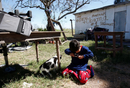 FILE PHOTO: A child plays in his yard in one of the unincorporated settlements in south Texas known as the colonias, immigrant-heavy areas that often lack basic municipal services and tend to support Democrats in elections. Los Fresnos, Texas March 1, 2009. REUTERS/Jessica Rinaldi (UNITED STATES)/File Photo