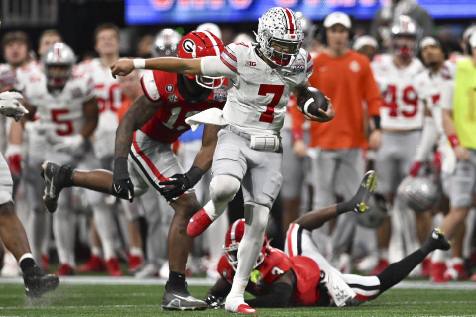 Ohio State quarterback C.J. Stroud (7) runs against Georgia during the second half of the Peach Bowl NCAA college football semifinal playoff game, Saturday, Dec. 31, 2022, in Atlanta. (AP Photo/Danny Karnik)