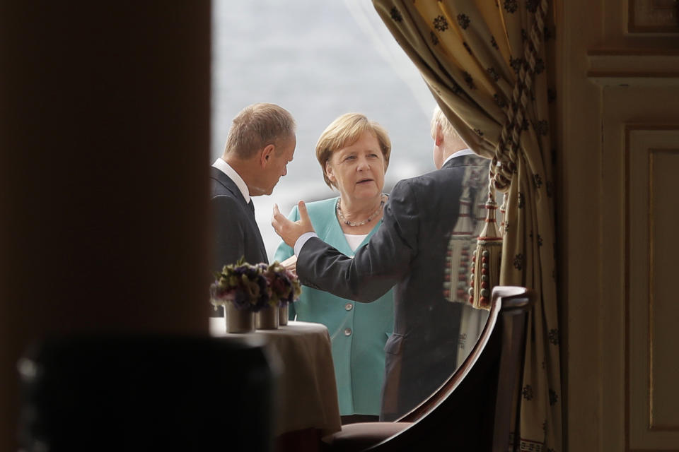 German Chancellor Angela Merkel, center, talks to President of the European Council Donald Tusk, left, and Britain's Prime Minister Boris Johnson during a G7 coordination meeting with the Group of Seven European members at the Hotel du Palais in Biarritz, southwestern France, Saturday, Aug.24, 2019. Efforts to salvage consensus among the G-7 rich democracies frayed Saturday in the face of U.S. President Donald Trump's unpredictable America-first approach even before the official start of the summit in southern France. (AP Photo/Markus Schreiber, Pool)