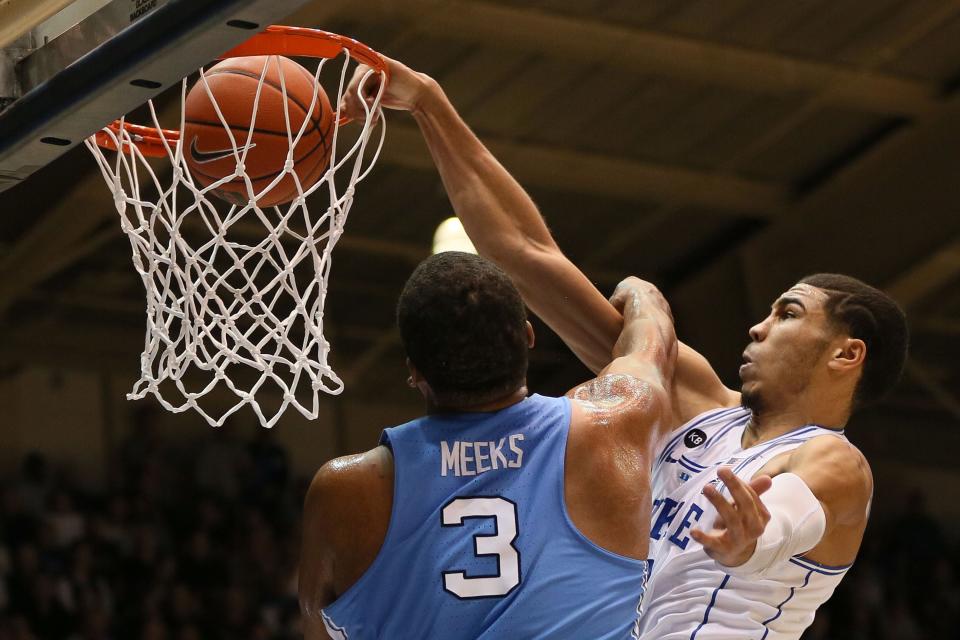 Duke forward Jayson Tatum dunks the ball over North Carolina forward Kennedy Meeks.