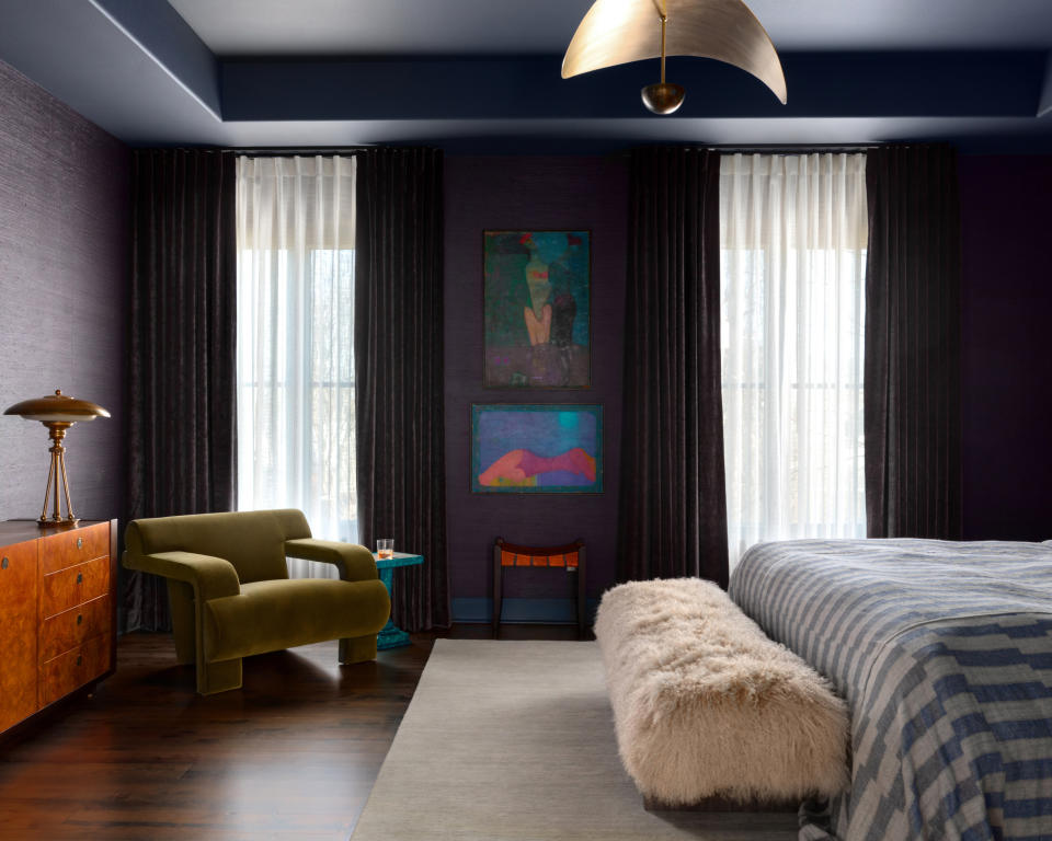 A colorful bedroom with contemporary furniture and wall art