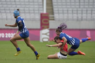 Britain's Helena Rowland, bottom, gets tackled by Russian Olympic Committee's Alena Tiron, in their women's rugby sevens match at the 2020 Summer Olympics, Thursday, July 29, 2021 in Tokyo, Japan. (AP Photo/Shuji Kajiyama)