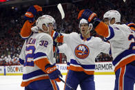 New York Islanders' Kyle MacLean (32) celebrates his goal with teammates during the first period in Game 1 of an NHL hockey Stanley Cup first-round playoff series against the Carolina Hurricanes in Raleigh, N.C., Saturday, April 20, 2024. (AP Photo/Karl B DeBlaker)