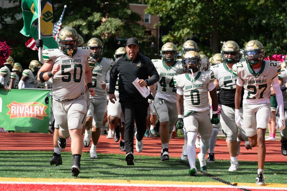 Head Coach Dan Marangi, center, runs onto the field with his team before the start of a football game between Bergen Catholic High School and St. Joseph Regional High School at Bergen Catholic High School in Oradell on Sunday, October 15, 2023.