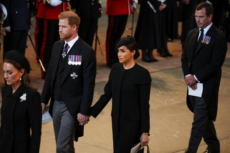 LONDON, ENGLAND - SEPTEMBER 14:  Catherine, Princess of Wales, Prince Harry, Duke of Sussex and Meghan, Duchess of Sussex and Peter Phillips arrive in the Palace of Westminster after the procession for the Lying-in State of Queen Elizabeth II on September 14, 2022 in London, England. Queen Elizabeth II's coffin is taken in procession on a Gun Carriage of The King's Troop Royal Horse Artillery from Buckingham Palace to Westminster Hall where she will lay in state until the early morning of her funeral. Queen Elizabeth II died at Balmoral Castle in Scotland on September 8, 2022, and is succeeded by her eldest son, King Charles III.  (Photo by Phil Noble-WPA Pool/Getty Images)