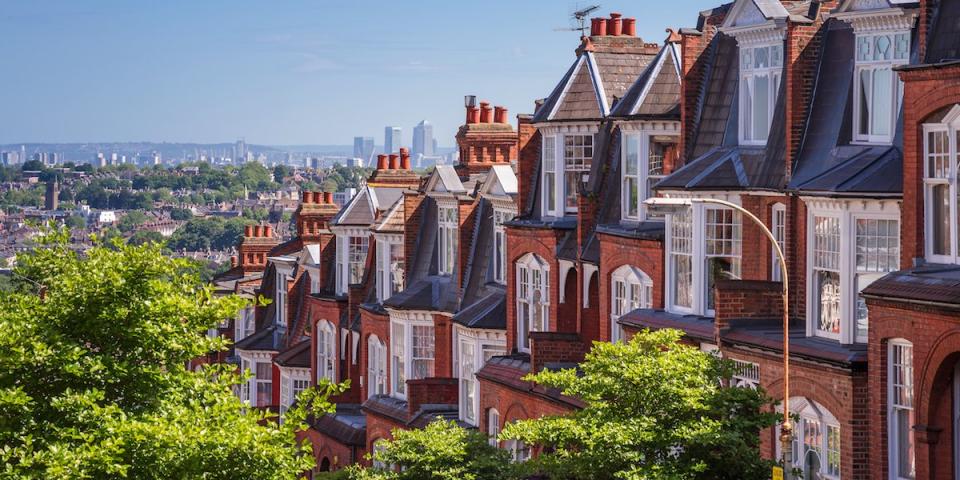 Brick houses of Muswell Hill and panorama of London with Canary Wharf