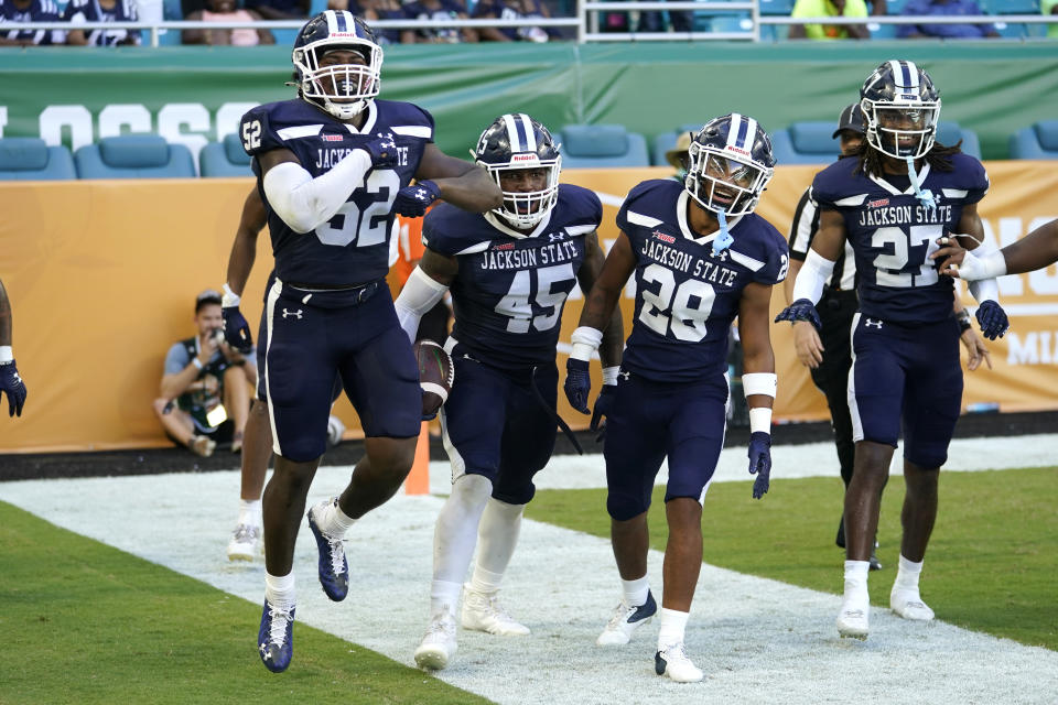 Jackson State linebacker Aubrey Miller Jr. (45) celebrates with Khalil Arrington (52), Tayvion Beasley (28) and Kevin May (27) after recovering a fumble for a touchdown during the second half of the Orange Blossom Classic NCAA college football game, Sunday, Sept. 4, 2022, in Miami Gardens, Fla. Jackson State won 59-3. (AP Photo/Lynne Sladky)