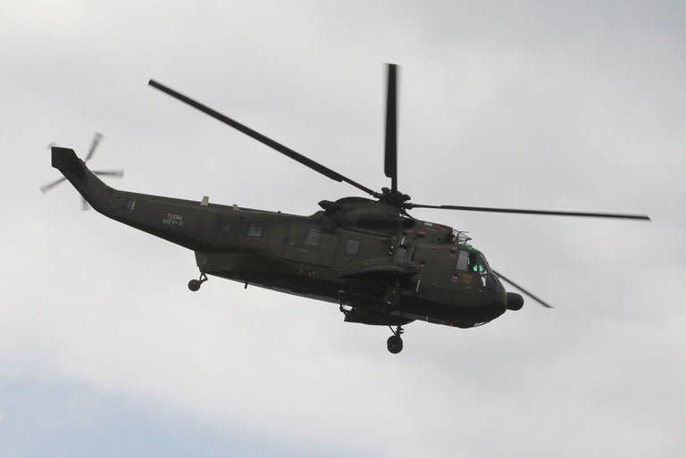 An army helicopter flies near the area where the stand-off between Filipino Sulu gunmen and Malaysian security forces is taking place on March 5, 2013. National police chief Ismail Omar told reporters at a press conference hours after the operation began that security forces were still taking fire from defiant insurgents, but had launched "mopping up" operations