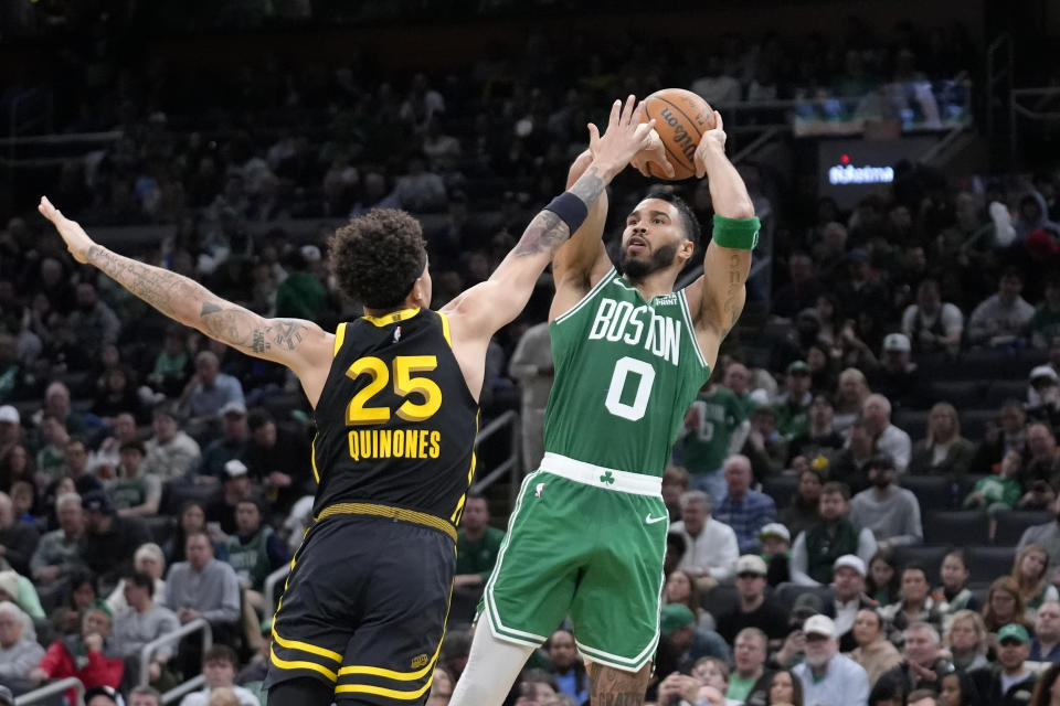 Boston Celtics forward Jayson Tatum (0) looks to shoot at the basket as Golden State Warriors guard Lester Quinones (25) defends in the second half of an NBA basketball game, Sunday, March 3, 2024, in Boston. (AP Photo/Steven Senne)