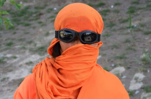 The women working in Jalabad's public gardens wear an ample fluorescent orange work blouse -- a stark contrast to the traditional sky-blue burka worn by the few other women seen in public in the city