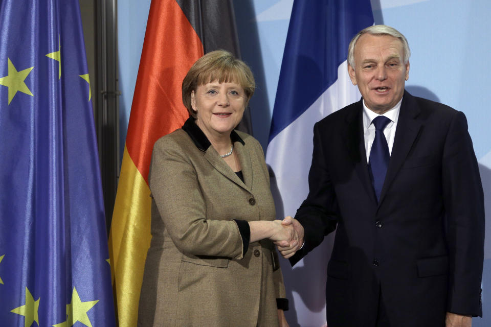 German Chancellor Angela Merkel, left, and the Prime Minister of France, Jean-Marc Ayrault, right, shake hands after a joint press conference as part of a meeting at the chancellery in Berlin, Germany, Thursday, Nov. 15, 2012. (AP Photo/Michael Sohn)