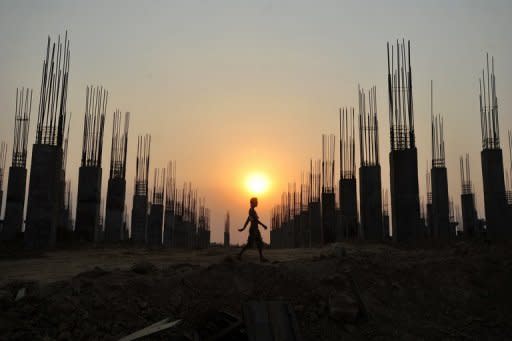 A labourer walks on a construction site in Naypidaw. As Myanmar prepares for an economic resurgence following the end of decades of military rule, wide-eyed firms from all over Asia are competing for a piece of the potentially lucrative pie