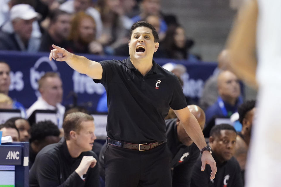 Cincinnati coach Wes Miller shouts to players during the first half of the team's NCAA college basketball game against BYU on Saturday, Jan. 6, 2024, in Provo, Utah. (AP Photo/Rick Bowmer)