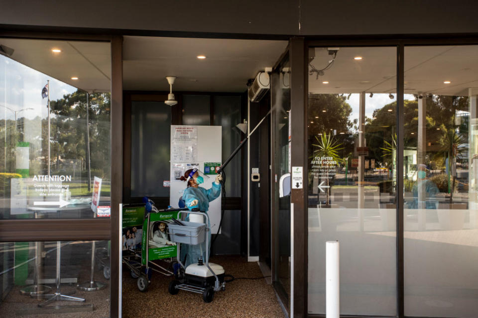 A cleaner is seen wearing full PPE during the disinfection of the Holiday Inn hotel in Melbourne, Australia. 