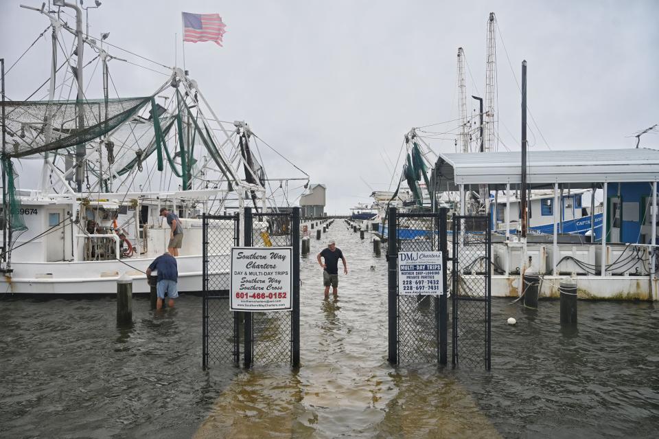 Fishermen secure their boats at Pass Christian Harbor in Mississippi in preparation for landfall of Tropical Storm Cristobal on June 7, 2020. The harbor was already flooded by storm surge.