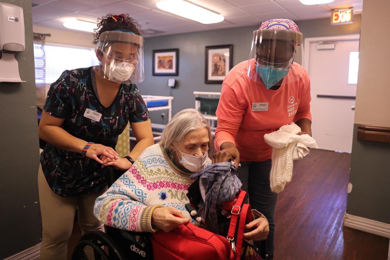 Certified nursing assistants Jordan Reid, left, and Marie Pierre-Louis prepare a resident for a shower at Focused Care at Stonebriar in Central Austin on Jan. 14, 2022.