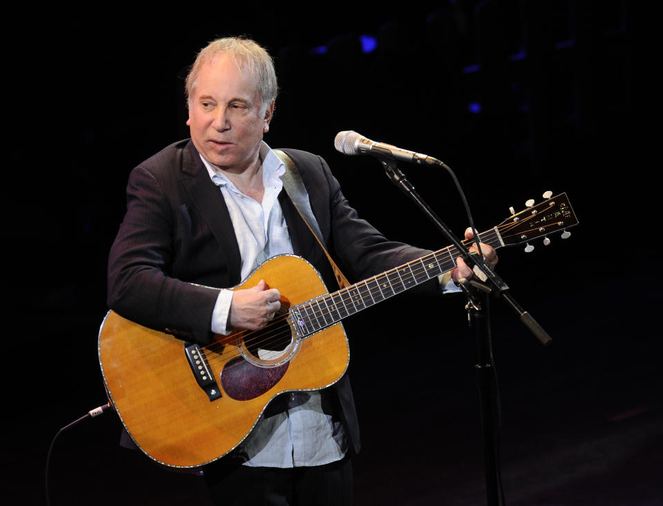 FILE - This April 2, 2012 file photo shows singer Paul Simon performing at "A Celebration of Paul Newman's Dream" to benefit "SeriousFun" an association of Hole in the Wall Camps at Avery Fisher Hall in New York. Police in Connecticut say Paul Simon and his wife, singer Edie Brickell, have been arrested on disorderly conduct charges. A New Canaan police spokeswoman provided no other details, except to say the arrests stemmed from an incident Saturday. An arraignment in Norwalk Superior Court is expected Monday afternoon. Simon is a 12-time Grammy winner and a member of The Songwriters Hall of Fame and the Rock n' Roll Hall of Fame — as half of the duo of Simon and Garfunkel and as a solo artist. Brickell's "What I Am," recorded with her band the New Bohemians, was a hit in 1988. The two were married in 1992. (AP Photo/Evan Agostini, File)