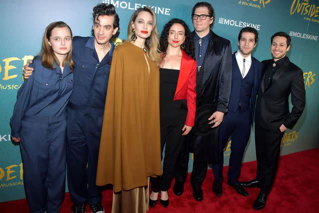 <p>Stephen Lovekin/Shutterstock</p> Vivienne and Angelina Jolie with 'The Outsiders' cast on April 11, 2024