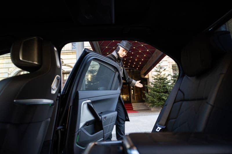 Car valet Sebastian Grossmann has opened the door of a car in front of the entrance to the Hotel Adlon Kempinski. The hospitality industry in Germany grew more slowly in 2023 than initially estimated last month, new figures released on Tuesday showed. Hannes P Albert/dpa