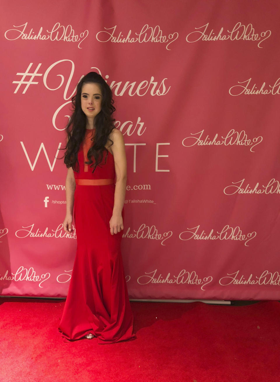 Model Marian Avila wears an outfit from the Talisha White 2019 spring collection on the red carpet during Fashion Week, Saturday, Sept. 8, 2018, in New York. Avila, a 21-year-old Spanish model with Down syndrome, fulfilled her dream to walk at New York Fashion Week thanks to White, the Atlanta designer she met through the magic of social media. (AP Photo/Leanne Italie)
